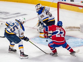 Blues center Jordan Kyrou couldn't prevent Canadiens' Cole Caufield from scoring the winning overtime goal against Blues goaltender Ville Husso Thursday night at the Bell Centre.