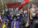 People take part in the May Day march in Montreal Saturday, May 1, 2021.