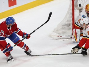 Montreal Canadiens' Daniel Carr (43) scores on backhand on Calgary Flames goalie David Rittich during first period NHL action in Montreal on Dec. 7, 2017.