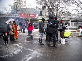 People gathered in downtown Ottawa during the Freedom Convoy protest, Sunday, Feb. 6, 2022. Ronald Marenger of SOS Quebec was with the group near Confederation park, hugging supporters and helping with the clean up of the park.