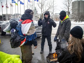 People gathered in Downtown Ottawa during the Freedom Convoy protest, Sunday, Feb. 6, 2022. Ronald Marenger of SOS Quebec was with the group near Confederation park helping with the clean up of the park.