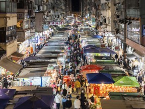 Shoppers walk through a street market in Hong Kong on Sun. Jan. 30, in preparation for the Lunar New Year celebrations on Feb. 1.