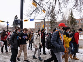 Students at Western Canada High School exit the school for their lunch break on their first day of being back in classes in the new year on Monday, January 10, 2022.