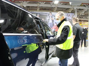 Stellantis CEO Carlos Tavares checks out a vehicle at the Windsor Assembly Plant on Wednesday, Feb. 9, 2022.