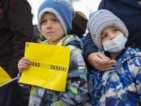 Brothers, Jasper Wachna, 6, and Brody Wachna, 4, join fellow members of Windsor's Ukrainian community as they hold a rally on Ottawa Street at Lanspeary Park to show support to Ukraine as it defends itself against a Russian invasion, on Friday, February 25 , 2022.