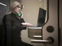 Mélanie Boivin, head of interior design at ADHOC Architectes, works in one of the new soundproof phone booths the firm recently created to allow for private phone calls and video conferences.  “If there's cacophony, people won't want to go back,” Boivin said.
