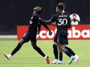 CF Montréal midfielder Ismael Kone, left, celebrates his goal against Santos Laguna with teammates forward Romell Quioto and defender Joel Waterman during the second half at Olympic Stadium on Feb. 23, 2022. 