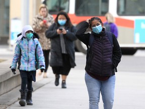 People wearing their masks along 6th St. SW. Tuesday, February 8, 2022.