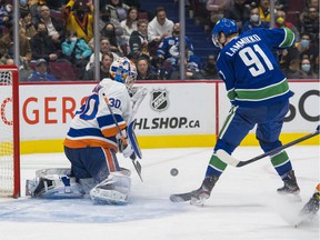 New York Islanders goalie Ilya Sorokin (30) makes a save on Vancouver Canucks forward Juho Lammikko (91) in the third period at Rogers Arena.