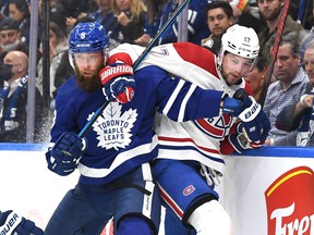 Canadiens forward Josh Anderson battles along the boards with Leafs defenseman Jake Muzzin in this October 2021 photo.