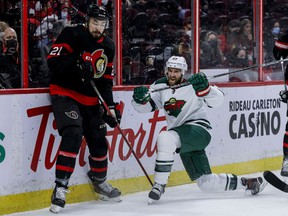 Ottawa Senators left wing Nick Paul (21) and Minnesota Wild defenseman Alex Goligoski (47) during first period NHL action at the Canadian Tire Centre.  February 22,2022.