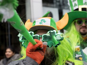 Jamie Wikan blows his horn as he takes part in the St. Patrick's Day parade in Montreal on March 17, 2019.