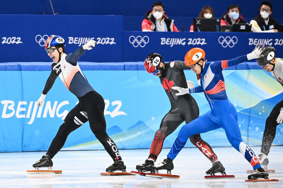 South Korea's Daeheon Hwang, left, finishes first ahead of Canada's Steven Dubois (centre) and Russia's Semen Elistratov in the A final of the men's 1,500-metre short-track speedskating event at Beijing 2022 Winter Olympic Games on February 9, 2022.