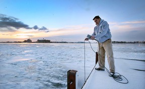 Mike McKay, executive director of the Great Lakes Institute for Environmental Research, is shown with a water quality monitor along the Detroit River banks in Windsor on Friday, Feb. 4, 2022.