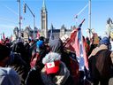A person carries a Confederate battle flag in front of Parliament Hill as truckers and supporters take part in a convoy to protest coronavirus disease (COVID-19) vaccine mandates for cross-border truck drivers in Ottawa, Ontario, Canada, January 29, 2022.