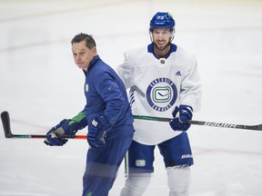 Canucks' Justin Dowling (#73) (right) at practice at Rogers Arena in Vancouver, BC Tuesday, October 12, 2021.