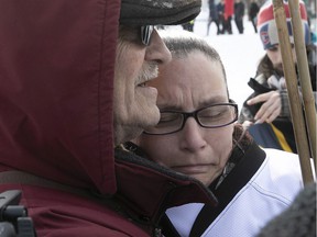 Lynne Baudouy, mother of Lucas Gaudet, is comforted by a member of the march to denounce violent crimes toward children and young adults in Montreal on Saturday, March 5, 2022. Her son was stabbed to death in February.