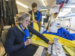 Ukrainian immigrants Lyudmyla Peregudova and husband Oleg Peregudov sew a 3.5-metre Ukrainian flag in their tailor shop in Town of Mount Royal.