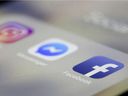 In this March 13, 2019, file photo, Facebook, Messenger and Instagram apps are displayed on an iPhone in New York.  Facebook co-founder Chris Hughes says it's time to break up the social media behemoth.  He says in a New York Times opinion piece that CEO Mark Zuckerberg has allowed a relentless focus on growth that crushed competitors 