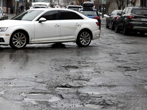 A series of pothole repairs on top of other pothole repairs makes Notre-Dame St. look like a cart path.