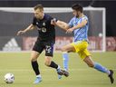 CF Montréal's Alistair Johnston, left, breaks away from Philadelphia Union's Leon Flach during second half MLS soccer action in Montreal on Saturday.