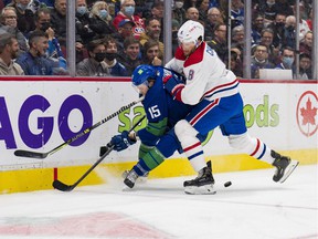 Montreal Canadiens defenseman Ben Chiarot (8) checks Vancouver Canucks forward Matthew Highmore (15) in the first period at Rogers Arena.