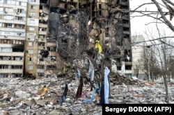 Cette photo montre un immeuble endommagé après un bombardement la veille dans la deuxième plus grande ville d'Ukraine, Kharkiv, le 8 mars 2022.