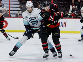 Ottawa Senators right wing Connor Brown (28) and Seattle Kraken defenseman Jamie Oleksiak (24) during first period NHL action at the Canadian Tire Center on Thursday.