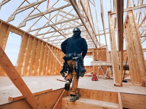 Jordan Ellis, a framer with JS Ellis Construction works on a single family housing build in the 1300 block of Clearwater Avenue in Windsor on Thursday, March 10, 2022.
