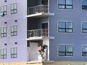 Construction workers are shown at a condominium project on McHugh Street in Windsor on Thursday, March 10, 2022.