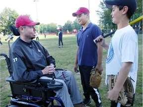 NDG Lynx baseball coach Carey Ashton discusses game strategy with Daniel Kost-Stephenson, right, and Danilo Cardoza at Trenholme Park in 2003.