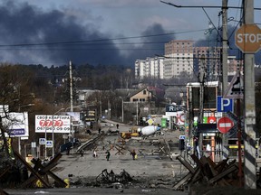 Residents evacuate the city of Irpin, north of Kyiv, on March 10, 2022.