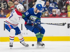 Montreal Canadiens defenseman Brett Kulak gets his stick into the body of Canucks center Elias Pettersson during their Wednesday game at Rogers Arena.