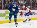 Winger Tanner Pearson, eyeing the puck while being pursued by Montreal's Jeff Petry during Wednesday's 5-3 Canucks victory, is a key contributor to the team's forecheck, one who 'wins his battles.'