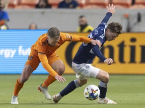 Houston Dynamo FC defender Adam Lundkvist (3) chases Vancouver Whitecaps FC midfielder Ryan Gauld (25) in the first half at PNC Stadium.  Photo: Thomas Shea-USA Today Sports
