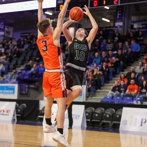 Unity Christian's Levi Van Egdom, who was named the tournament MVP, attempts to block a shot from Glenlyon Norfolk's Zach Scott.  Unity Christian defeated Glenlyon Norfolk 89-71 to win the 1A BC Boys Basketball Finals at the Langley Events Center on Saturday, March 13, 2022. Photo: Paul Yates, Vancouver Sports Pictures