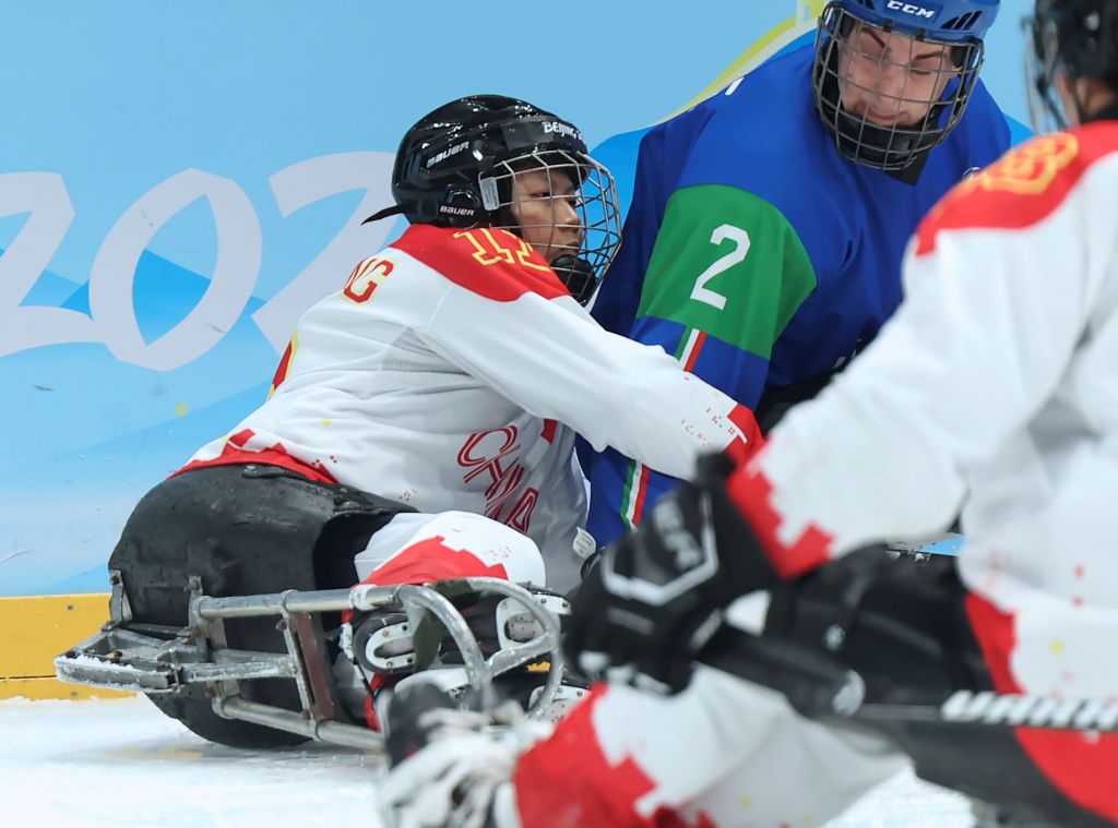 Yu Jing of China (left) competes during China's preliminary round para ice hockey game against Italy at the 2022 Winter Olympics in Beijing, China.