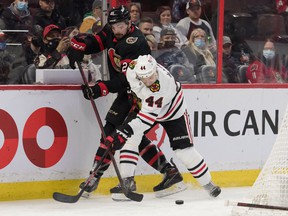 Senators left-winger Nick Paul (21) battles with Blackhawks defenseman Calvin De Haan (44) for possession of the puck during the second period of Saturday's game.