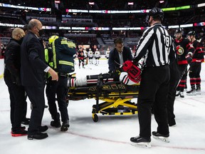 Connor Murphy (5) of the Chicago Blackhawks helped off the ice on a stretcher after a big hit from Parker Kelly (45) of the Ottawa Senators [NOT PICTURED] during the first period at the Canadian Tire Center on March 12, 2022.