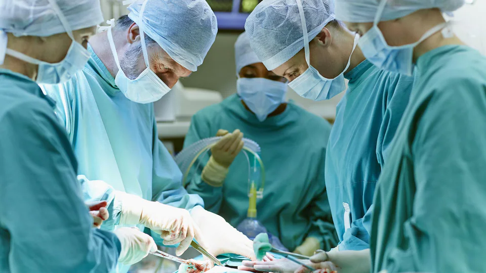 Des chirurgiens opèrent un patient dans une salle d'opération. 