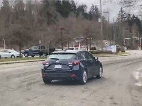 The suspect in Friday's shooting in North Vancouver fled in a newer model dark blue Mazda 3 hatchback.