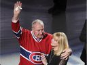 Guy Lapointe, waves to the crowd, next to his wife, Louise, during the retirement of Lapointe's sweater number at the Bell center in Montreal on Nov. 8, 2014.