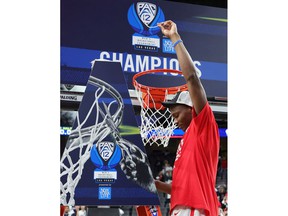 Bennedict Mathurin of the Arizona Wildcats celebrates after cutting a piece of a basketball net following the team's 84-76 victory over the UCLA Bruins to win the Pac-12 Conference basketball tournament championship game at T-Mobile Arena in Las Vegas on March 12, 2022 .