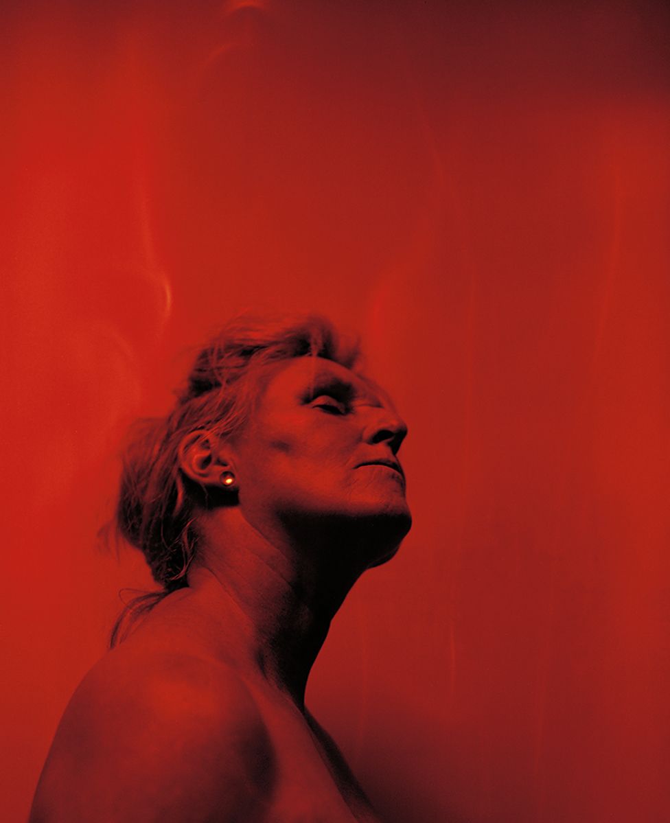A red portrait of a woman with her eyes closed
