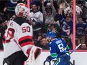 Vancouver Canucks' Bo Horvat (53) celebrates his goal against New Jersey Devils goalie Nicolas Daws (50) during the second period of an NHL hockey game in Vancouver, on Tuesday, March 15, 2022.