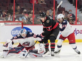 Columbus Blue Jackets goalie Elvis Merzlikins makes a save in front of Ottawa Senators left wing Brady Tkachuk in the second period at the Canadian Tire Center.