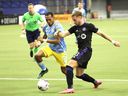 CF Montréal midfielder Djordje Mihailovic and Philadelphia Union midfielder José Andrés Martínez battle for the ball during the second half at the Olympic Stadium in Montreal on March 5, 2022.
