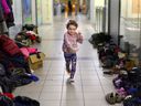 A refugee child runs at temporary accommodation, after fleeing the Russian invasion of Ukraine, in Rzeszow, Poland, on Wednesday.