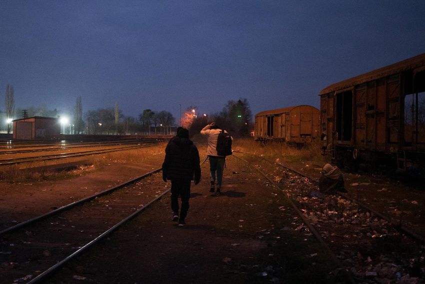 Three young men from Afghanistan leave a train station in Sombor, Serbia, hoping to find a taxi driver heading to the border with Hungary, on March 9, 2022.