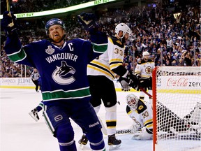 Henrik Sedin celebrates after Daniel Sedin (not pictured) scored a goal in the third period against Tim Thomas of the Boston Bruins during Game 2 of the 2011 NHL Stanley Cup Final at Rogers Arena on June 4, 2011.